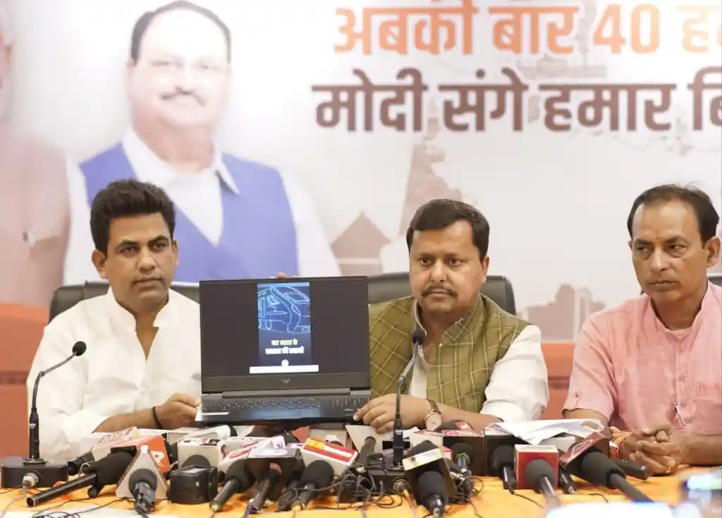 BJP ministers showcasing drone show plan during press meet.